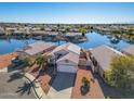 House on the lake with solar panels and a two-car garage at 11021 W Tonto Ln, Peoria, AZ 85373