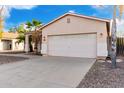 Front view of a one-story house with a two-car garage at 1187 E Cowboy Cove Trl, San Tan Valley, AZ 85143