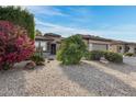 Single story home with colorful landscaping and a two-car garage at 15303 W Paradiso Ct, Surprise, AZ 85374