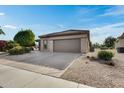 Single-story home with a two-car garage and desert landscaping at 15303 W Paradiso Ct, Surprise, AZ 85374