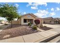 House exterior showcasing a well-maintained front yard and landscaping at 21995 N 76Th Ln, Peoria, AZ 85383
