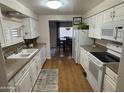 White kitchen with modern appliances and tile backsplash at 4065 E University Dr # 373, Mesa, AZ 85205