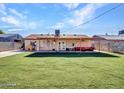 Spacious backyard with artificial turf and covered patio at 6826 W Pierson St, Phoenix, AZ 85033