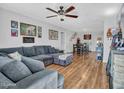 Open living area with L-shaped sectional sofa and hardwood floors at 6826 W Pierson St, Phoenix, AZ 85033