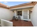 Welcoming front porch with tiled flooring and seating area at 14209 W Sky Hawk Dr, Sun City West, AZ 85375