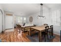 Open concept dining area with wood floors and light walls at 17221 N Thornberry Dr, Surprise, AZ 85374