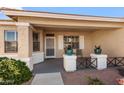 Covered front porch with seating and attractive planters at 17221 N Thornberry Dr, Surprise, AZ 85374