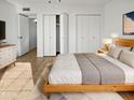 Spacious main bedroom with large bed, double closets and wood dresser at 3007 W Redfield Rd, Phoenix, AZ 85053