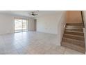 Living room with sliding glass doors and carpeted stairs at 688 W Carlsbad Dr, San Tan Valley, AZ 85140