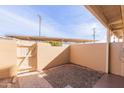 Small, private patio area with a gravel yard and gated access at 1425 E Desert Cove Ave # 32, Phoenix, AZ 85020