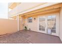 Private patio with double doors leading to the interior and a small yard at 1425 E Desert Cove Ave # 32, Phoenix, AZ 85020