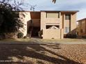 Tan two-story building with stairs and a small patio area at 1942 S Emerson -- # 222, Mesa, AZ 85210