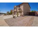 Two-story house with a desert landscape and brick driveway at 30276 W Crittenden Ln, Buckeye, AZ 85396