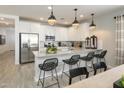 Modern kitchen with stainless steel appliances and island at 8028 E Petra Ave, Mesa, AZ 85212