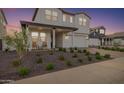 Two story home with front porch and landscaped yard at 17329 W Gretna St, Surprise, AZ 85388