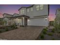 Two story home with front yard landscaping and a paved driveway at 17329 W Gretna St, Surprise, AZ 85388