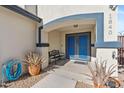 Front entry with blue double doors and a decorative bench at 1840 E Avenida Del Oro --, Phoenix, AZ 85022