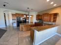 Spacious kitchen with island, granite countertops, and wood cabinets at 2120 E Catamaran Dr, Gilbert, AZ 85234