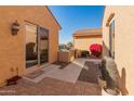 Backyard access with a walkway leading to a sliding glass door at 27106 W Marco Polo Rd, Buckeye, AZ 85396