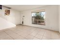 Living room with tiled floors and large window at 3524 W Dunlap Ave # 138, Phoenix, AZ 85051