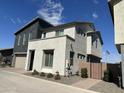 Modern two-story home with gray and white exterior and private gated entry at 4856 S Tune --, Mesa, AZ 85212