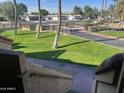 Landscaped lawn area with palm trees and a walkway at 4901 S Calle Los Cerros Dr # 202, Tempe, AZ 85282