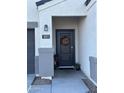 Modern front door with a fall-themed wreath and potted plants at 5311 W San Gabriel Ave, Laveen, AZ 85339