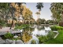 Picturesque pond with a wooden footbridge, arches, and tranquil water features at 6161 N 59Th Pl, Paradise Valley, AZ 85253