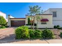 Spanish style home with a brick driveway and mature landscaping at 6317 E Pinchot Ave, Scottsdale, AZ 85251