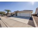 House exterior showcasing a two-car garage and driveway at 7813 E Nopal Ave, Mesa, AZ 85209