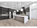 Modern kitchen with dark cabinetry, large island, and stainless steel appliances at 8714 E Tether Trl, Scottsdale, AZ 85255