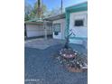 Mobile home with gravel landscaping and decorative features at 9623 E Baywood Ave, Mesa, AZ 85208
