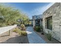 Stone pathway leads to the home's entrance, showcasing the property's landscaping at 10040 E Happy Valley Rd # 446, Scottsdale, AZ 85255