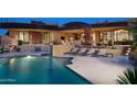 Inviting pool area with comfortable lounge chairs and a water feature at 11271 E Cinder Cone Trl, Scottsdale, AZ 85262