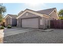 View of home's side elevation, including the garage and a side yard at 1231 W Hawken Way, Chandler, AZ 85286