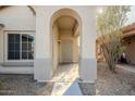 Covered entryway with arched doorway and security screen door at 15313 W Lundberg St, Surprise, AZ 85374