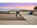 Single-story house with a two-car garage, and a gravel yard at sunset at 2110 W Silvergate Dr, Chandler, AZ 85224