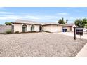 Single-story house with a two-car garage and gravel landscaping at 2110 W Silvergate Dr, Chandler, AZ 85224