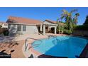 Inviting backyard oasis featuring a sparkling pool and relaxing patio area at 4047 E Rowel Rd, Phoenix, AZ 85050