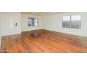 Bright living room featuring hardwood floors and large windows at 533 W Prickly Pear Dr, Casa Grande, AZ 85122