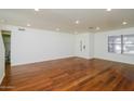 Open living room, hardwood floors, recessed lighting, and half bathroom at 533 W Prickly Pear Dr, Casa Grande, AZ 85122