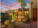 Ornate entry gate with pathway, surrounded by desert landscaping at 5640 E Miramonte Dr, Cave Creek, AZ 85331