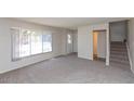 Bright living room featuring neutral carpeting and stairs at 6713 N 44Th Ave, Glendale, AZ 85301