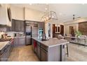 Gourmet kitchen with island, stainless steel appliances, and ample cabinetry at 7979 E Evening Glow Dr, Scottsdale, AZ 85266