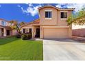 Tan two-story house with a grassy yard and attached garage at 9462 N 94Th Ln, Peoria, AZ 85345