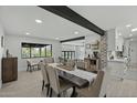 Dining area with a rustic table and view to the kitchen and pool at 12524 E Saddlehorn Trl, Scottsdale, AZ 85259