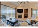 Spacious living room with fireplace, built-in shelving, and access to balcony at 14850 E Grandview Dr # 242, Fountain Hills, AZ 85268