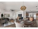 Open living and dining area with hardwood floors and modern lighting at 19668 E Carriage Way, Queen Creek, AZ 85142