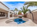 Inviting kidney-shaped pool with a stone water feature in the backyard at 19668 E Carriage Way, Queen Creek, AZ 85142