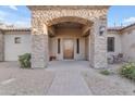 Stone entryway with arched alcove and wooden door at 23323 S 199Th Pl, Queen Creek, AZ 85142